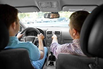 Image showing car driving school instructor teaching male driver