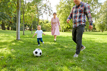 Image showing happy family playing soccer at summer park