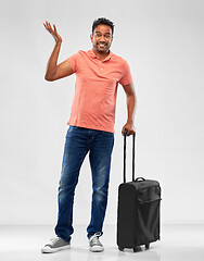 Image showing indian man in polo shirt with travel bag shrugging