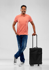 Image showing smiling indian man in polo shirt with travel bag