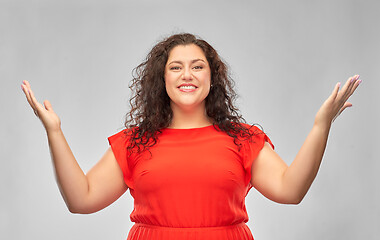 Image showing happy smiling woman in red dress looking up