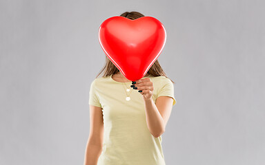 Image showing woman covering face with heart-shaped balloon