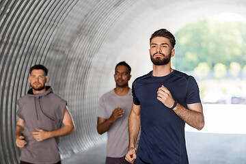 Image showing young men or male friends running outdoors