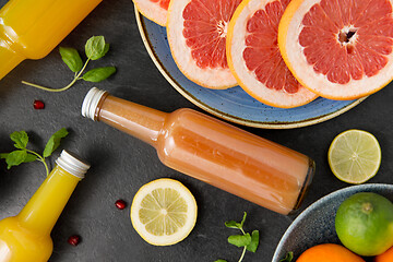 Image showing glass bottles of fruit and vegetable juices