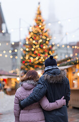Image showing happy senior couple hugging at christmas market