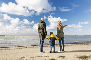 Image showing happy family at autumn beach looking at sea