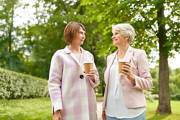 Image showing senior women or friends drinking coffee at park