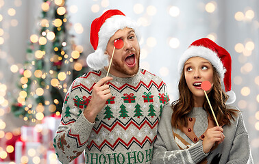 Image showing couple with christmas party props in ugly sweaters