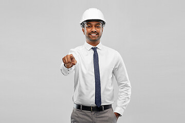 Image showing indian male architect in helmet showing something