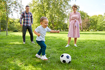 Image showing happy family playing soccer at summer park