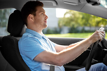 Image showing smiling man or driver driving car