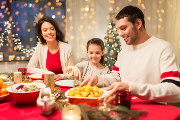 Image showing happy family having christmas dinner at home