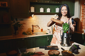 Image showing Staying at home woman using mixer for to prepare vegetarian food