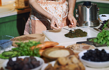 Image showing Staying at home woman preparing and cooking vegetarian food