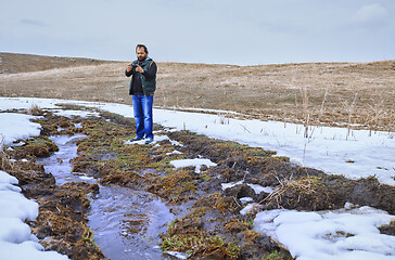 Image showing Man at the swamp using geolocation on smartphone 