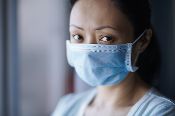 Image showing Woman staying at home wearing protective surgical mask