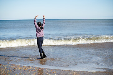 Image showing Happy woman having fun at the ocean