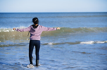 Image showing Happy woman having fun at the ocean