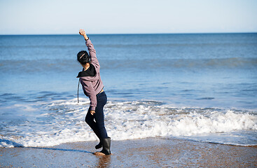 Image showing Happy woman having fun at the ocean