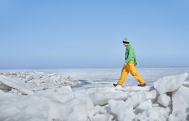 Image showing Young adult man outdoors exploring icy landscape