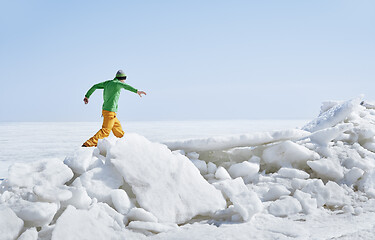 Image showing Young adult man outdoors exploring icy landscape