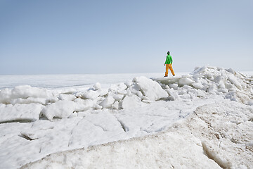 Image showing Young adult man outdoors exploring icy landscape