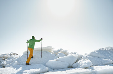 Image showing Young adult man outdoors with walking sticks exploring icy lands