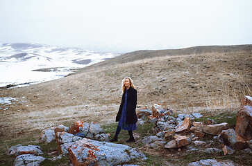 Image showing Serious woman walking in the winter landscape