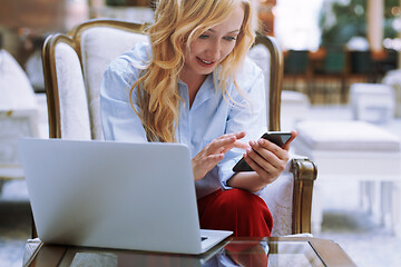 Image showing Businesswoman using smartphone in the modern bank lobby