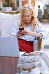 Image showing Businesswoman using smartphone in the modern bank lobby