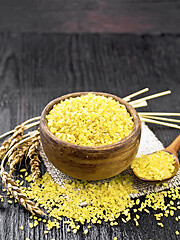 Image showing Bulgur in bowl on dark board