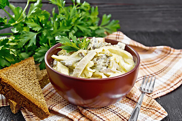 Image showing Salad with squid and champignons in bowl on board