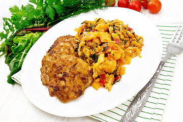 Image showing Fritters meat with cabbage in plate on board