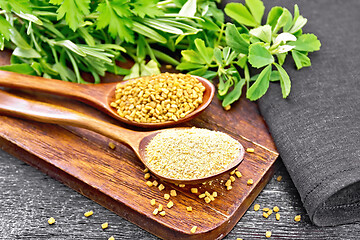 Image showing Fenugreek in two spoons with herbs on black board