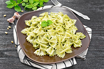 Image showing Farfalle with pesto in plate on board