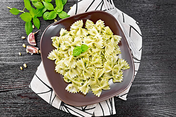 Image showing Farfalle with pesto in plate on dark board top