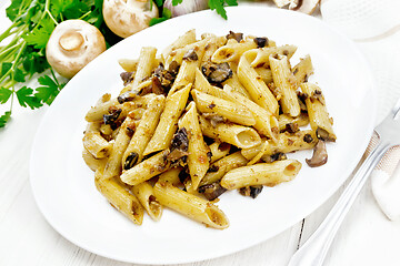 Image showing Pasta with mushrooms in white plate on light board