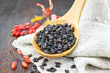 Image showing Barberry dried in spoon on wooden board