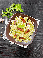 Image showing Farfalle with pesto and bacon on board top
