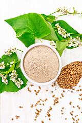 Image showing Flour buckwheat brown in bowl on light board top