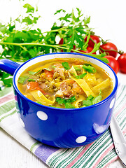 Image showing Soup with mung and noodles in blue bowl on light board