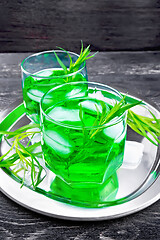 Image showing Lemonade Tarragon with ice in two glasses on black board