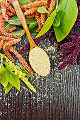 Image showing Amaranth groats in spoon on dark board top