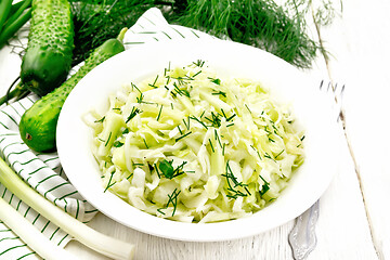 Image showing Salad of cabbage with cucumber in plate on board