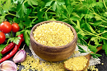 Image showing Bulgur in bowl with vegetables on board