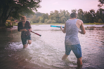 Image showing young men having fun with water guns