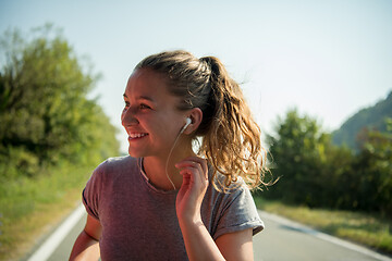 Image showing woman jogging along a country road