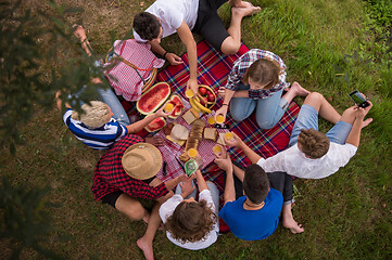 Image showing top view of group friends enjoying picnic time