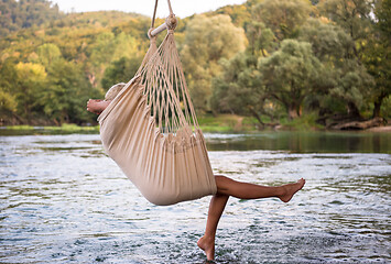 Image showing blonde woman resting on hammock