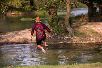 Image showing man jumping into the river